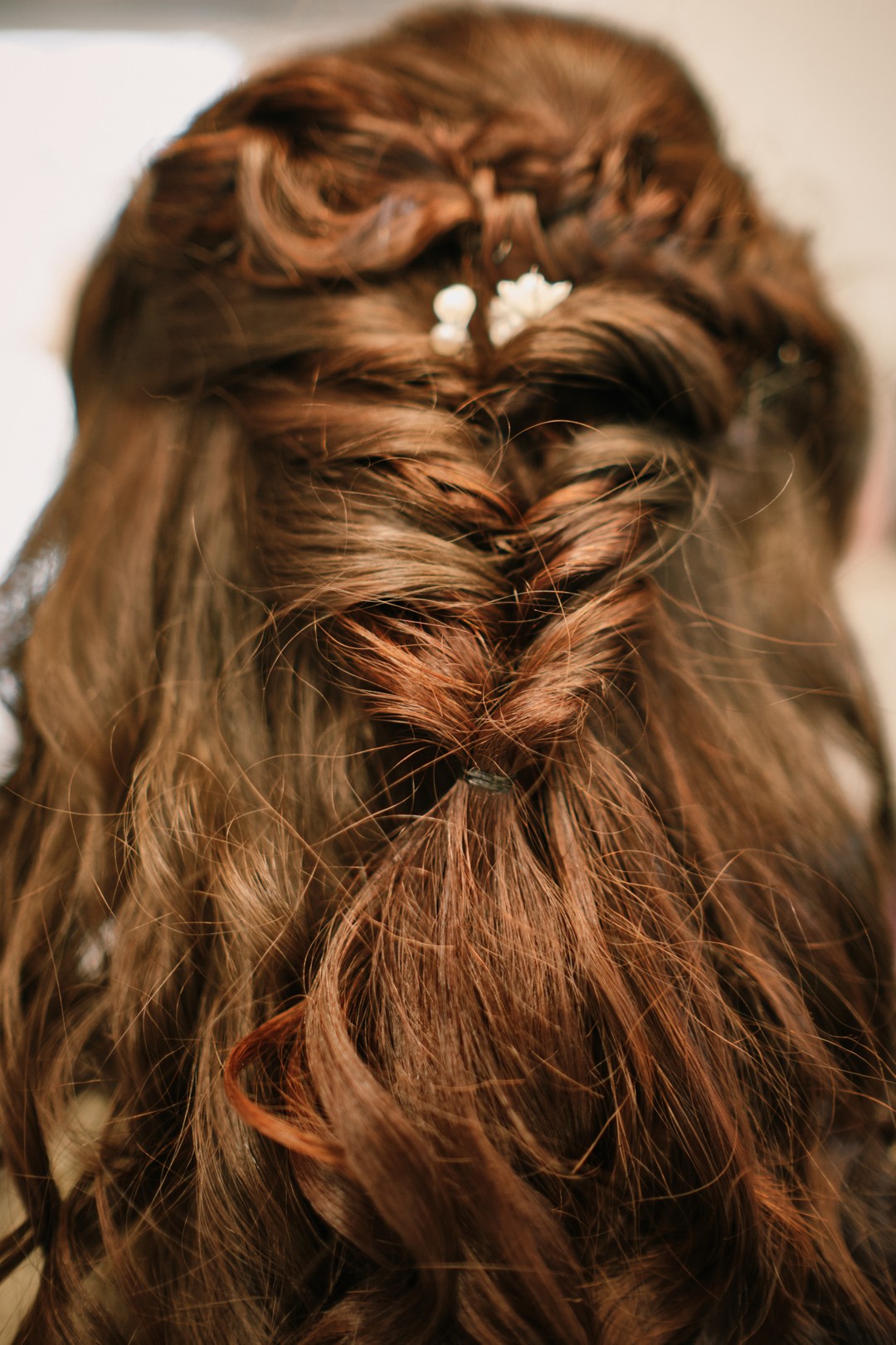 Miriam’s hair being done during the wedding preparations.