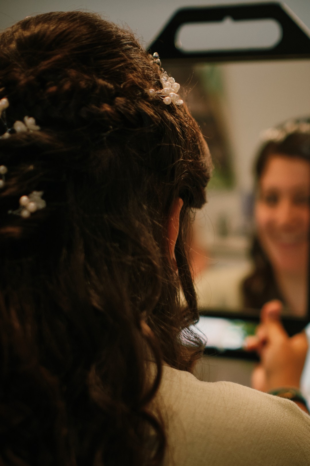Miriam looks at herself in the mirror during the preparations.