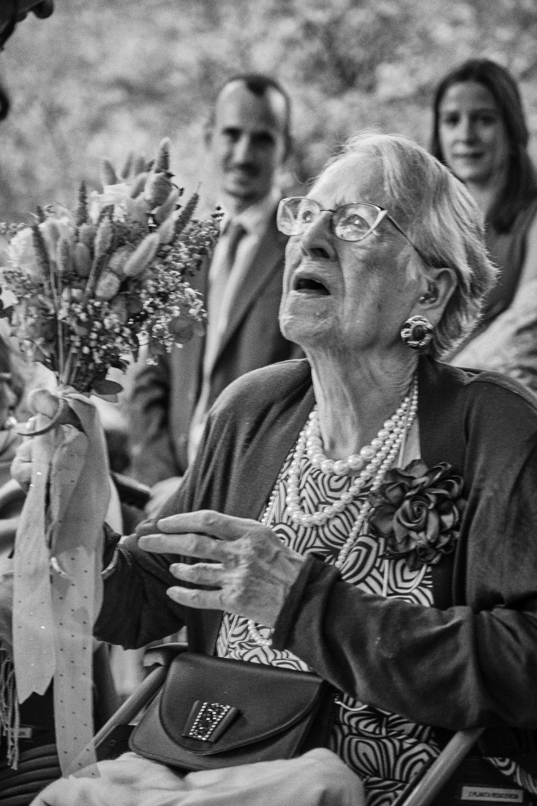A guest listens to the ceremony, visibly moved.