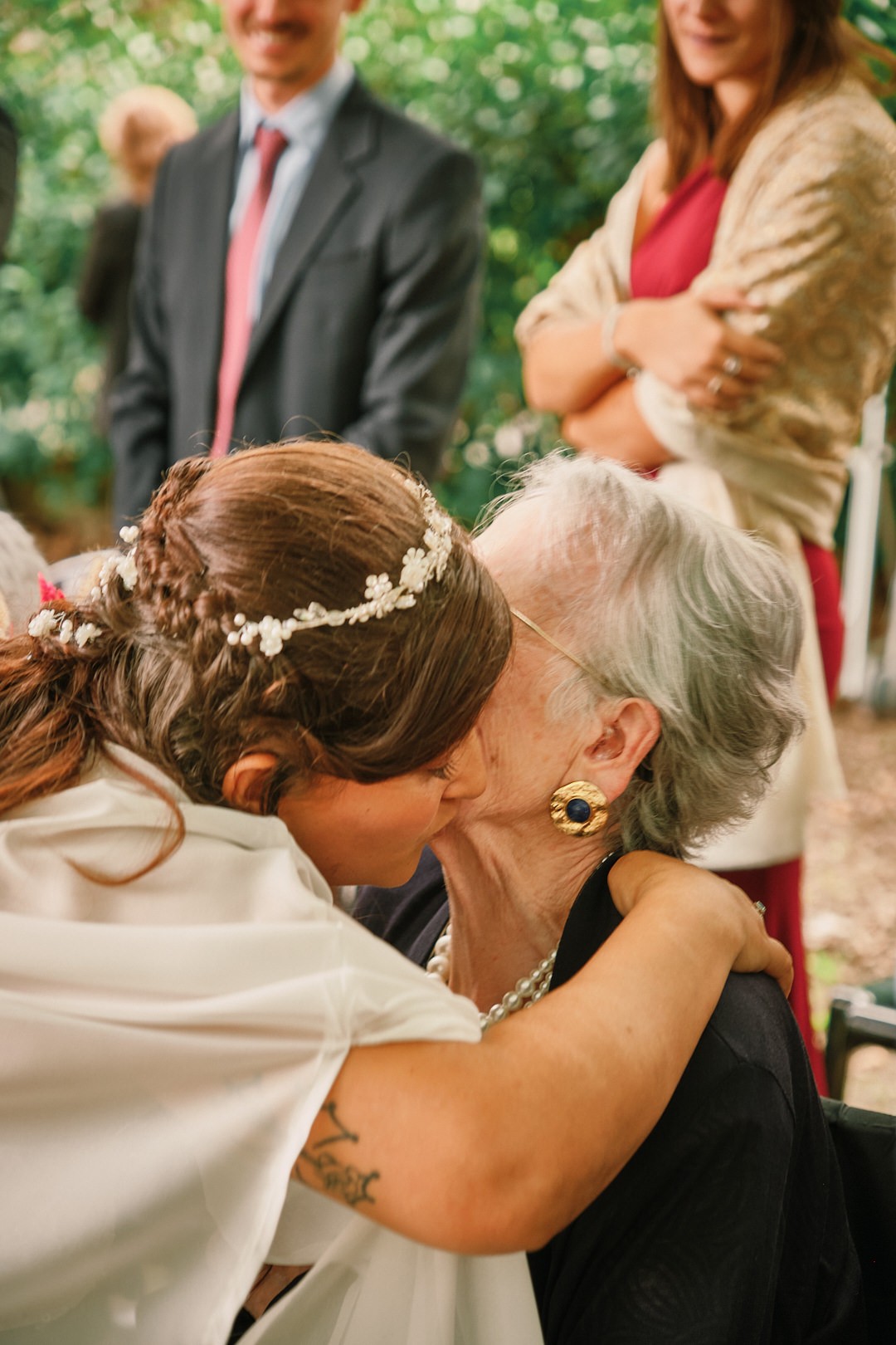 Miriam kisses an older guest after the ceremony.