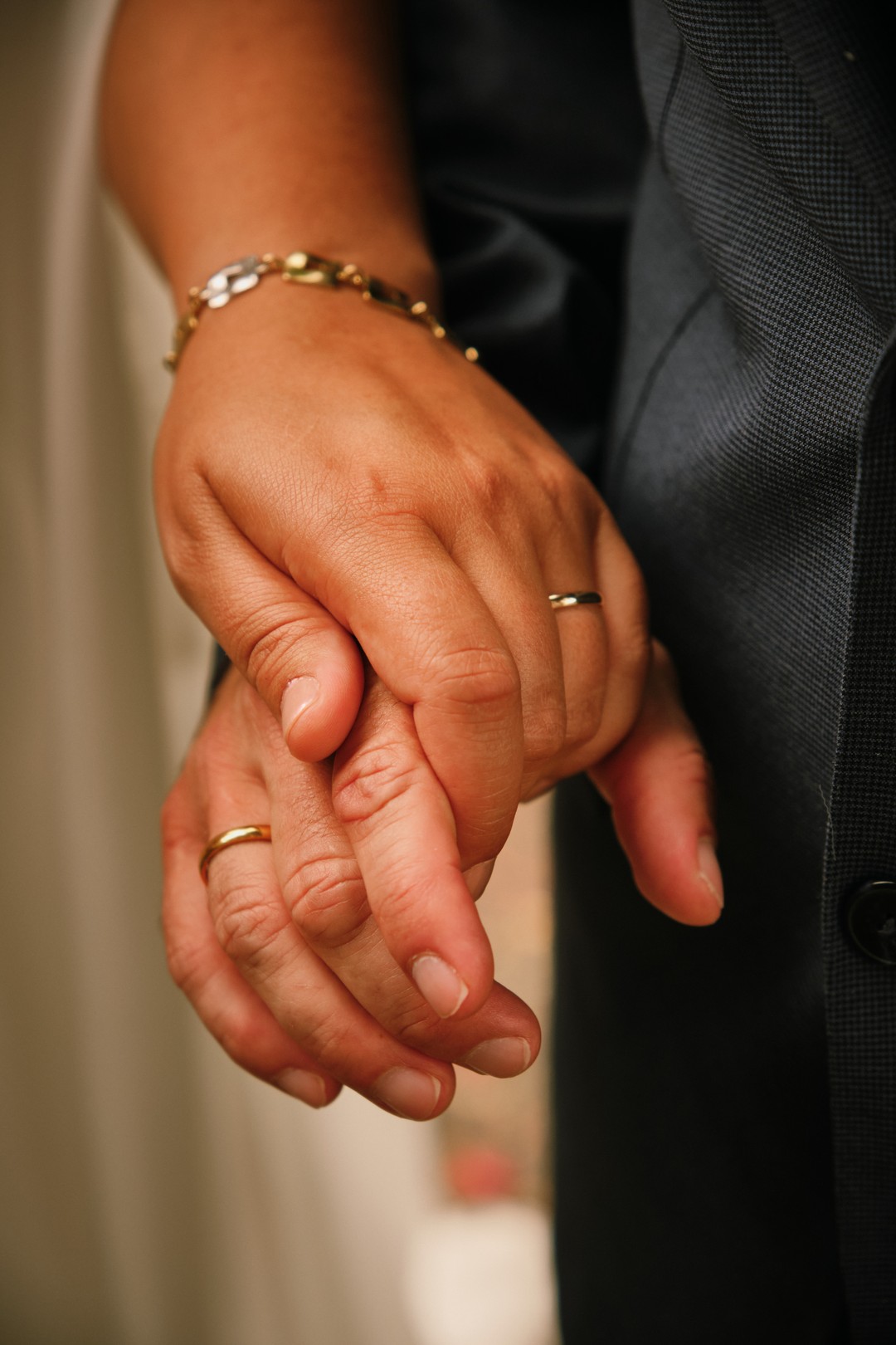 Miriam and Alejandro’s hands together, with their wedding rings.