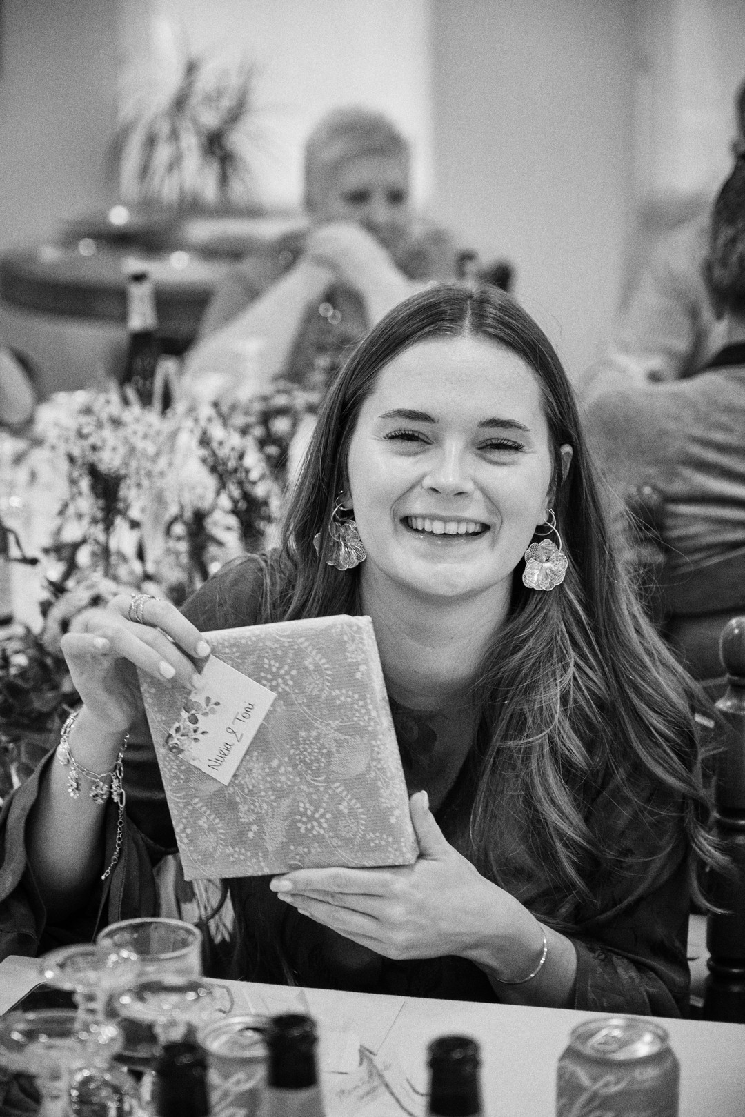 A guest smiles while reading a card.