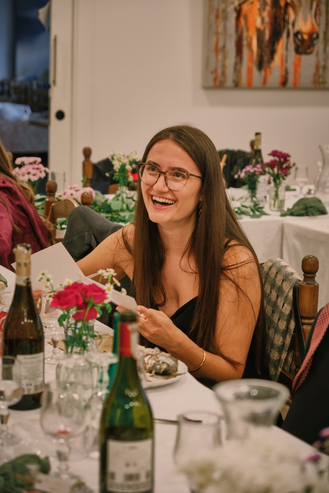 A guest smiles as she discovers a message during the meal.